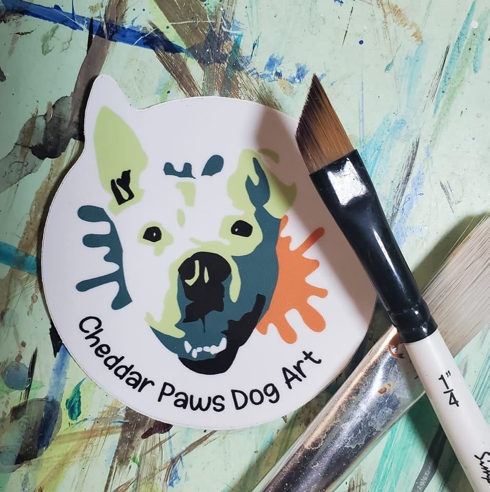 a paintbrush next to a round white sticker with a dog face