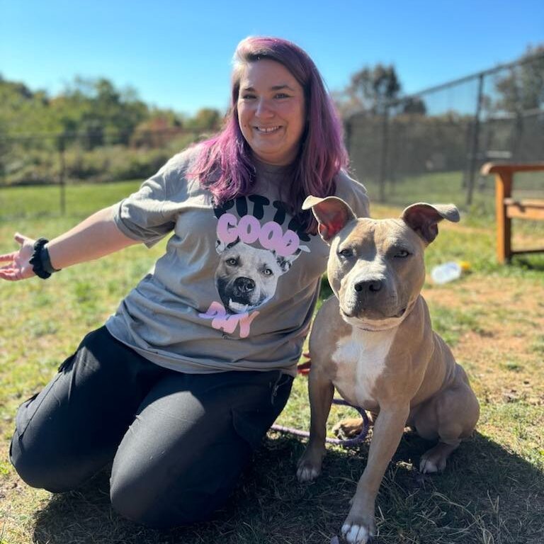 a woman with purple hair and a dog