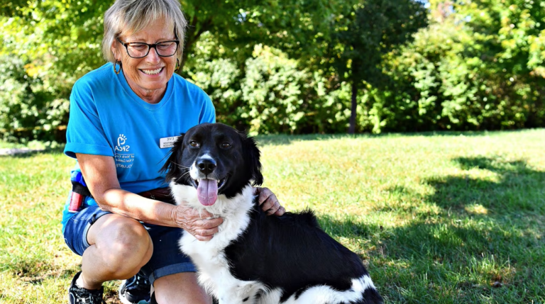 a woman petting a dog